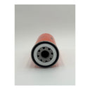 An orange oil filter is lying on a white background, showing some of its internal components.